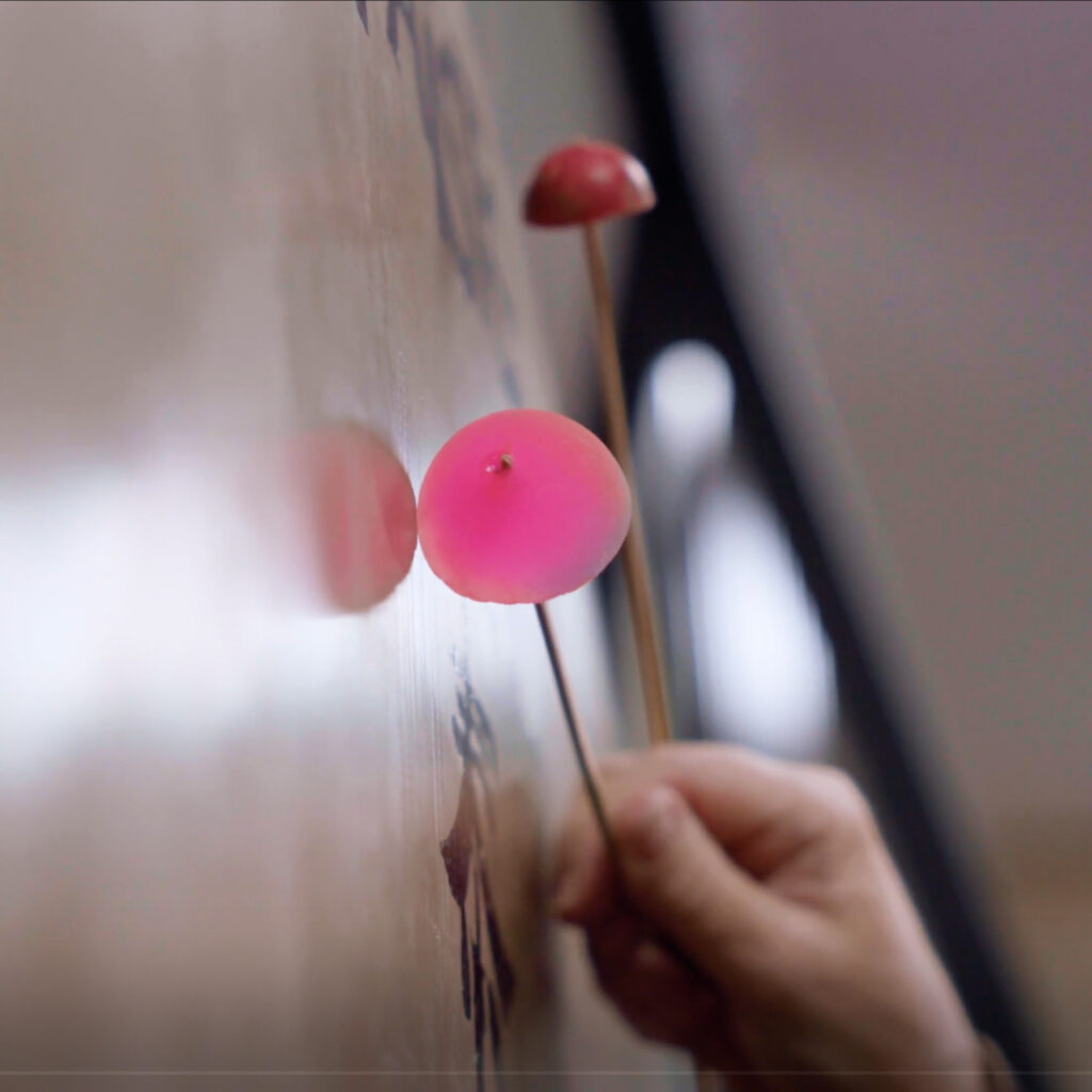 A close-up of Evelyn's hand as she plays a 60" Paiste Tam-Tam with home-made super-ball mallets.