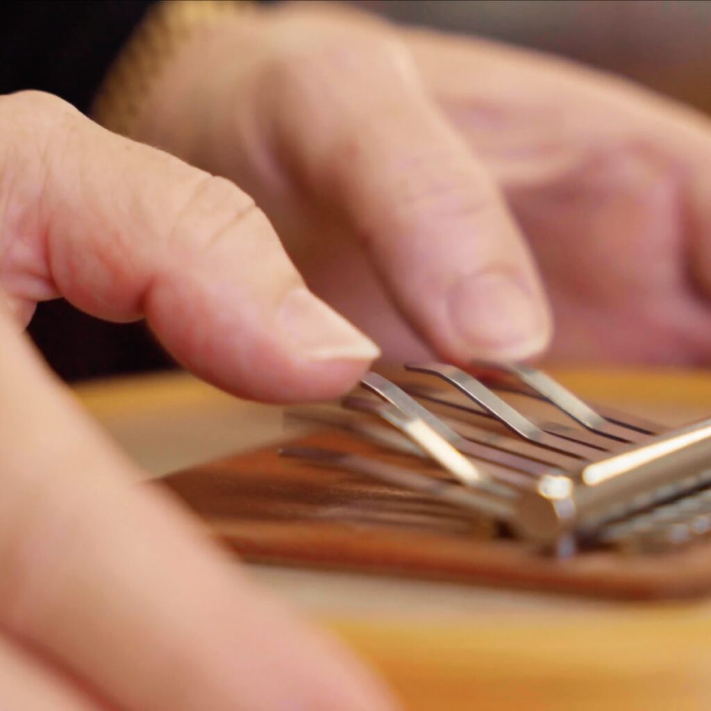 Evelyn's hands, as she plays a Sansula, belonging to The Evelyn Glennie Collection.