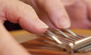 Evelyn's hands, as she plays a Sansula, belonging to The Evelyn Glennie Collection.