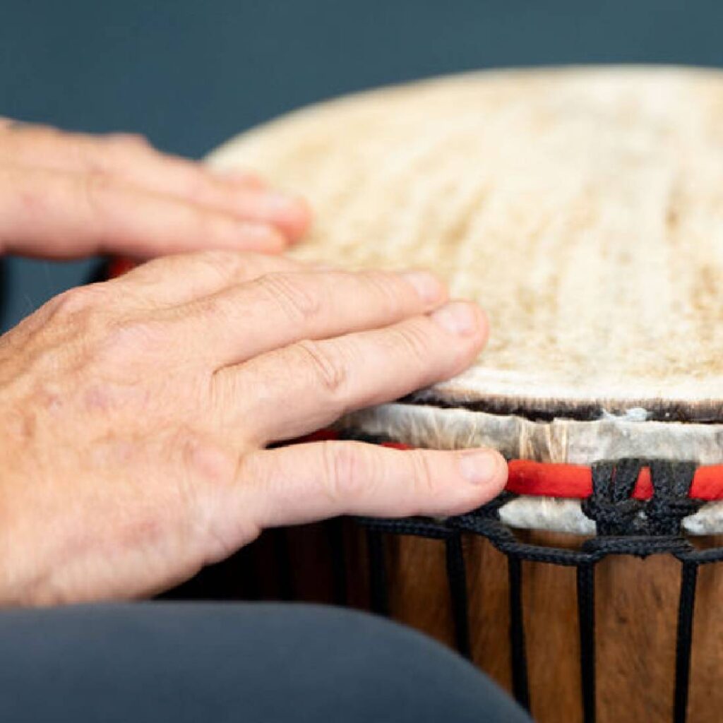 A Djembe, from The Evelyn Glennie Collection, being played by a participant in a 'Who's Listening' workshop