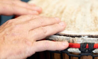 A Djembe, from The Evelyn Glennie Collection, being played by a participant in a 'Who's Listening' workshop