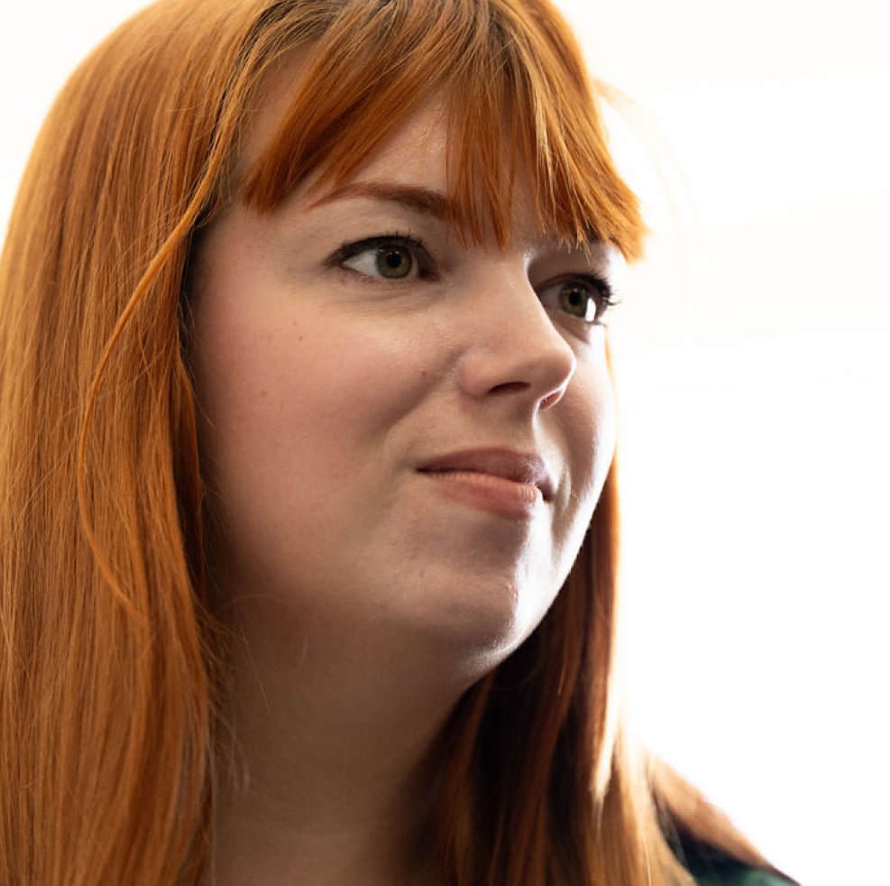 A striking photo of a young, red-headed woman, as she takes part in a 'Who's Listening' workshop.