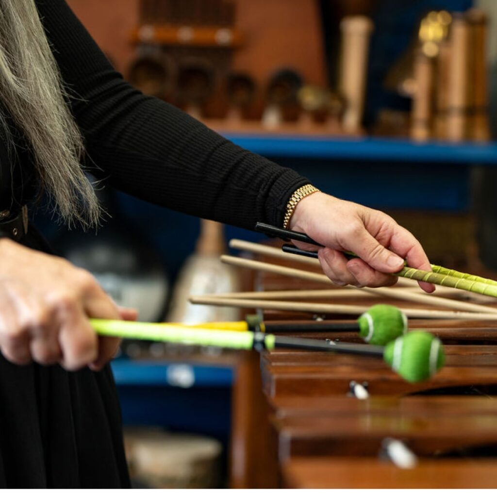 Evelyn playing a Marimba during a 'Who's Listening' workshop.