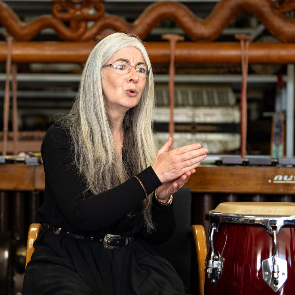 Evelyn, expressively using her hands, in discussion with participants during a 'Who's Listening' workshop.