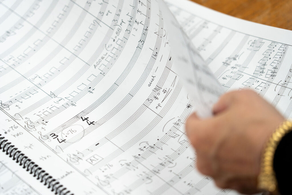 Evelyn's hand turning a couple of pages from a music score, which in this case is Sunrise.